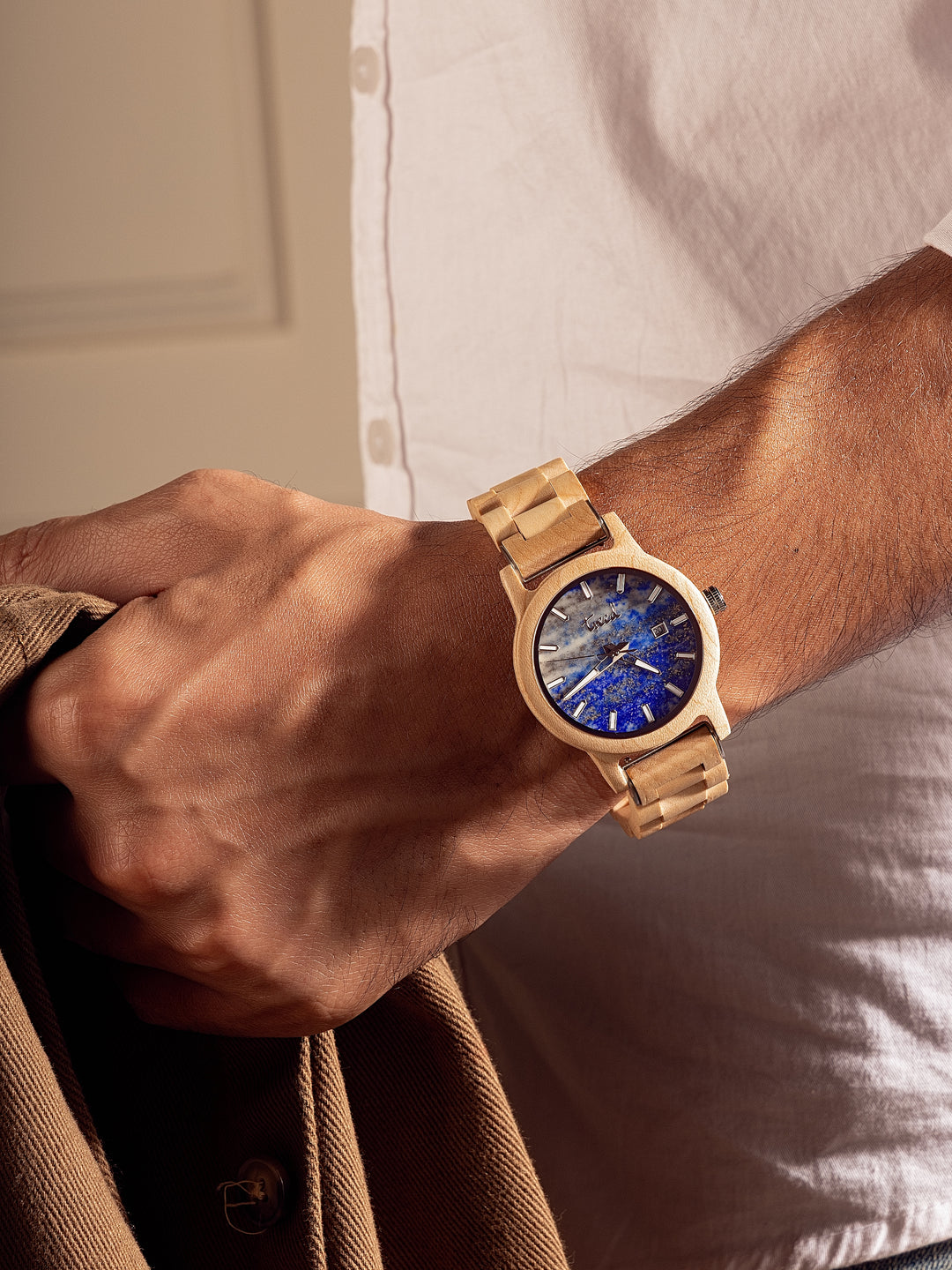 Treed Alpine lapis dial watch worn on wrist in natural light