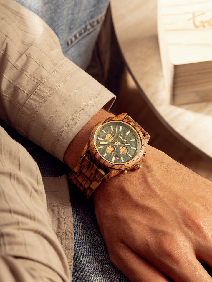 Zebrawood wooden watch with green marble dial worn on wrist